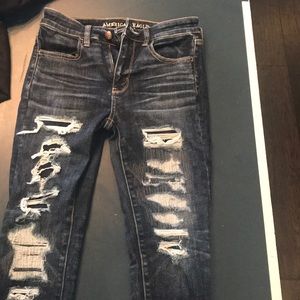 Distressed dark denim jeans